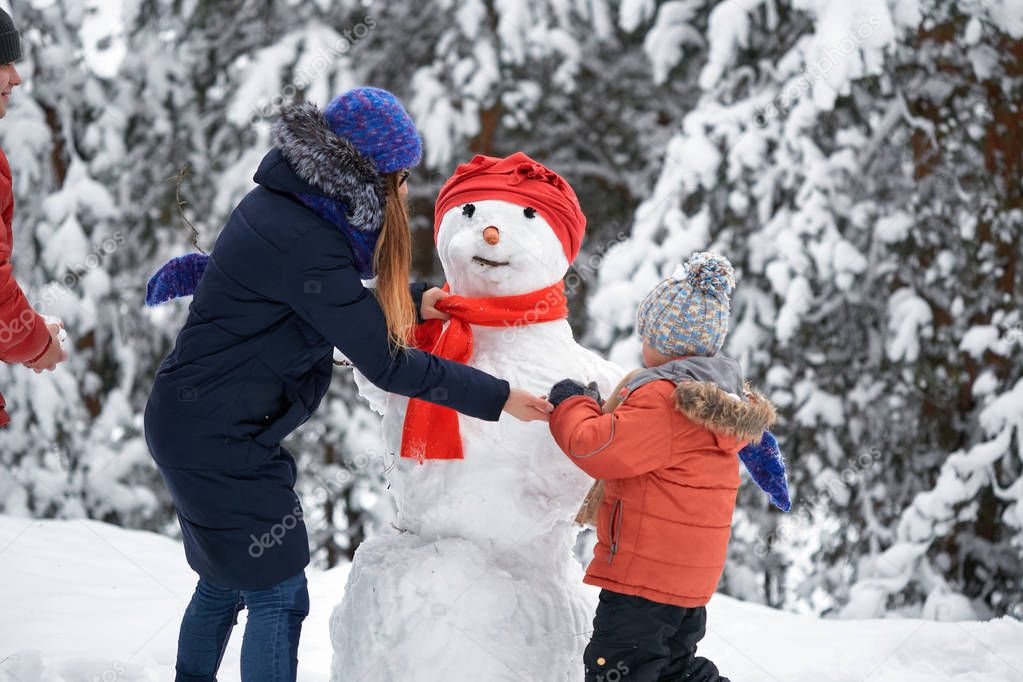 winter fun. a girl and a boy making snowballs.