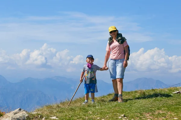 Mount Baldo, Italy - August 15, 2017: Happy mother with her son walking tourists on the mountain. — Stock Photo, Image