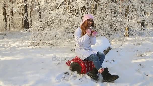 Beautiful Girl Pink Hat Mittens Winter Snowy Forest Drinking Tea — Stock Video