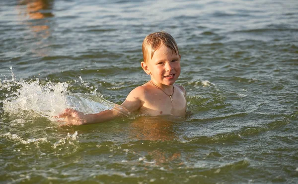 O menino está nadando no mar . — Fotografia de Stock