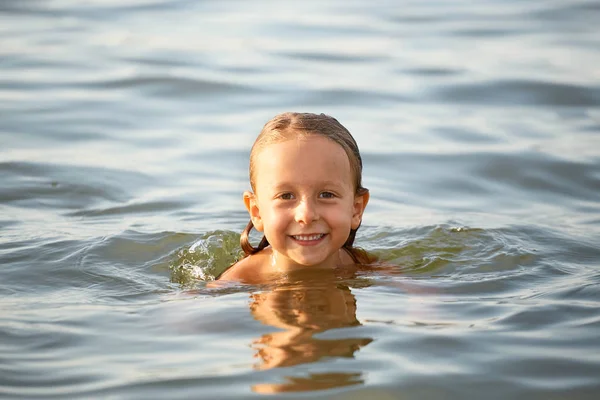 Menina se divertindo tomando banho no mar . — Fotografia de Stock