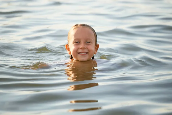 Menina se divertindo tomando banho no mar . — Fotografia de Stock