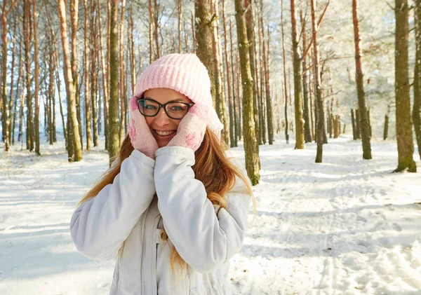 Girl in a knitted hat and scarf on a background of autumn …