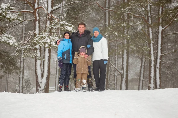 Portrait of a happy family on a winter forest background. — Stock Photo, Image