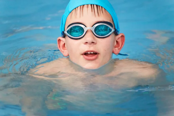 GRODNO, Belarus - Health resort Porechye. Portrait of a boy in swimming goggles bathed in the pool.