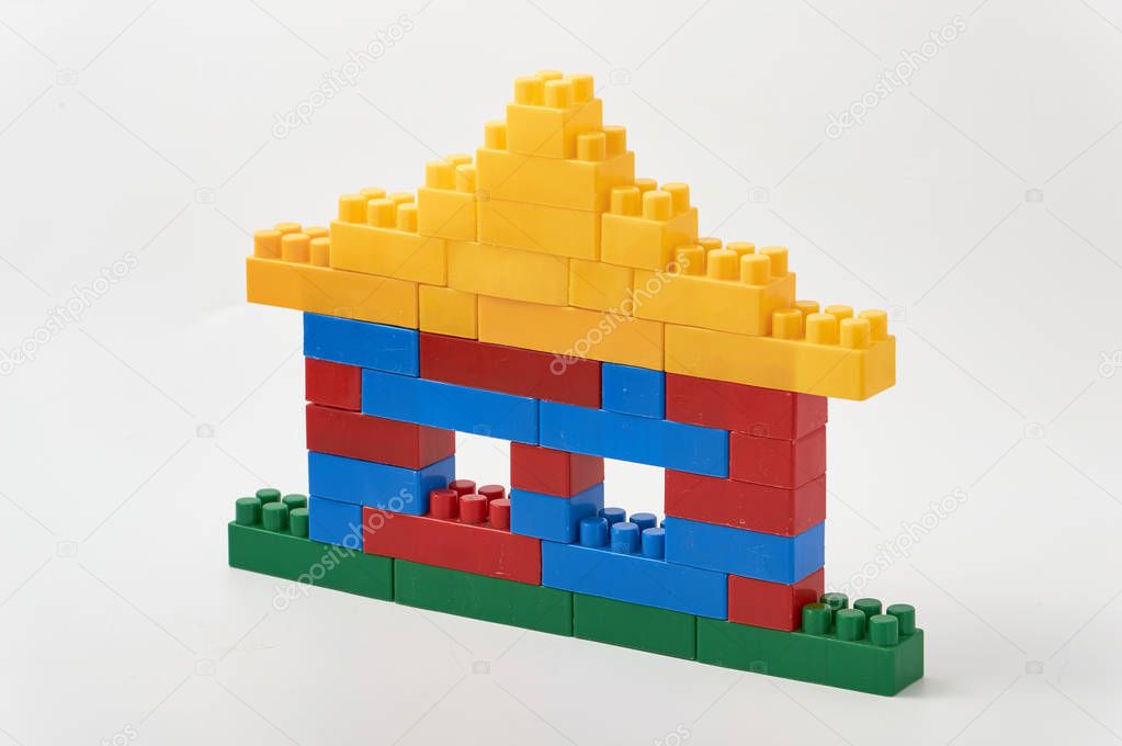 house with windows and a roof of colored cubes designer on a white background