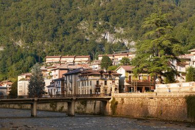 San Pellegrino Terme, Italy - August 18, 2017: Beautiful embankment of the Brembo River. clipart