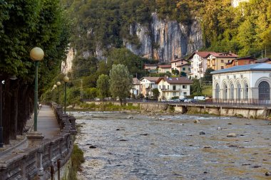 San Pellegrino Terme, Italy - August 18, 2017: Beautiful embankment of the Brembo River. clipart