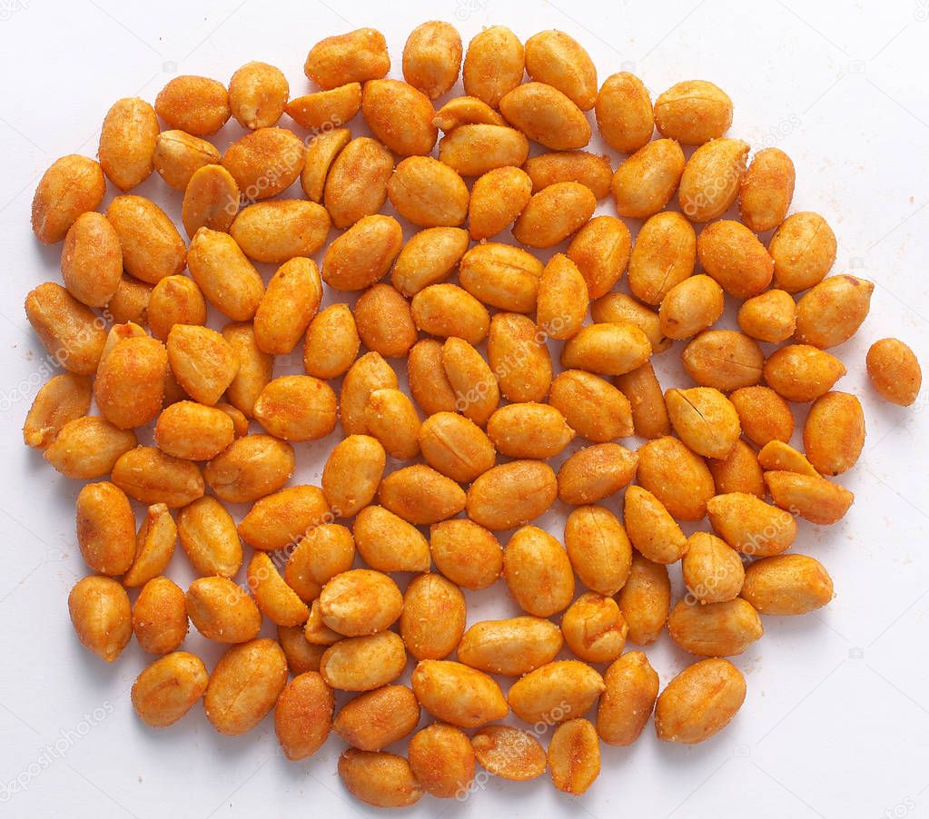 Salted peanuts with red sprinkling on a white background.