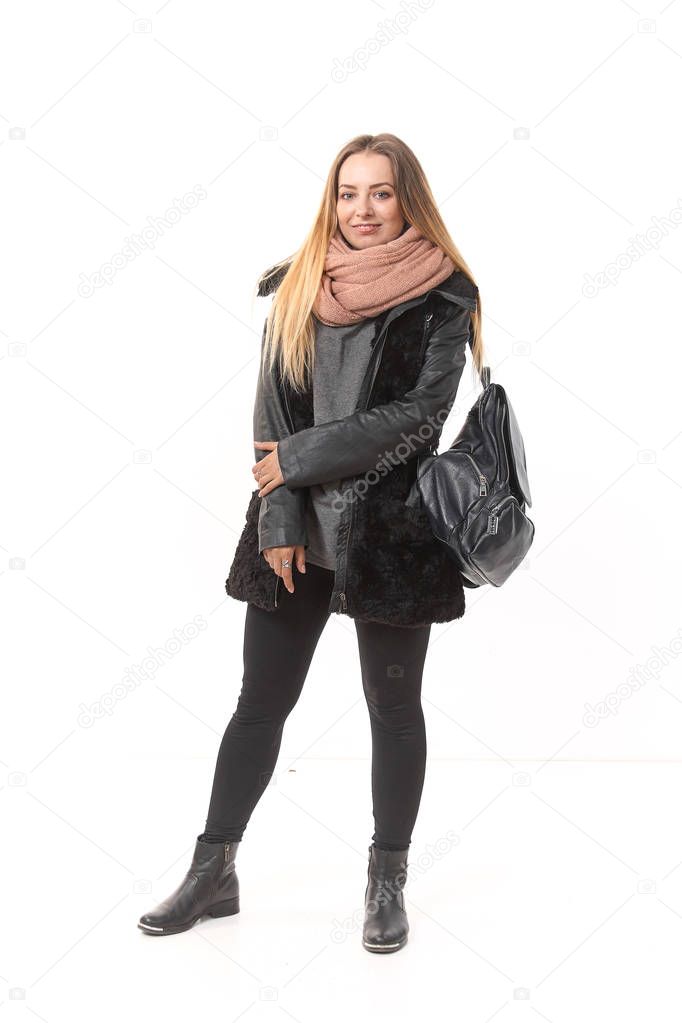 A girl in demi-season clothes with a full-length bag on a white background.