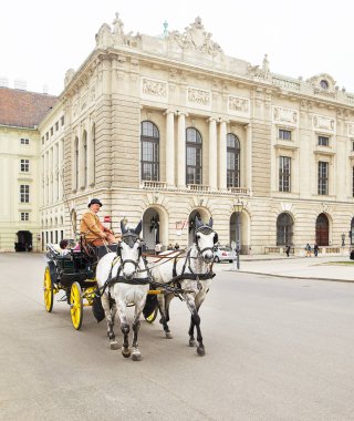 Vienna, Austria - 15 April 2018: Crew with horses for tourists. clipart