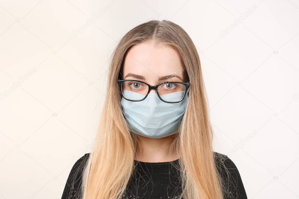 girl in medical mask with respirator on white background.