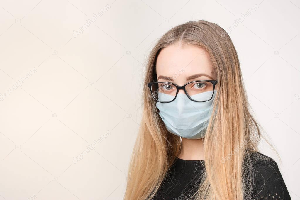 girl in medical mask with respirator on white background.