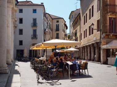Vicenza, İtalya - 13 Ağustos 2019: Güneşli şemsiyeli açık hava kafe