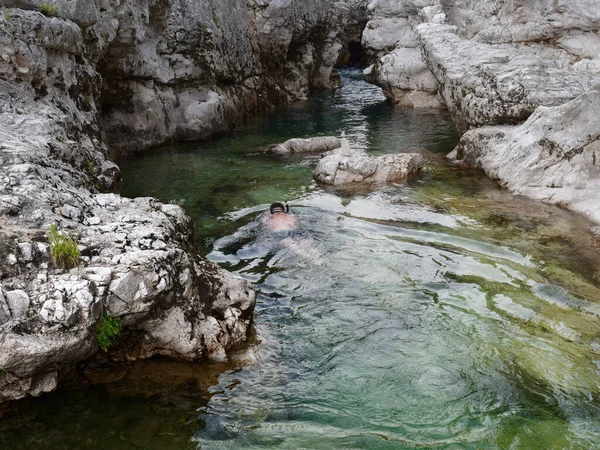 A man swims in a mountain river. Italy — ストック写真