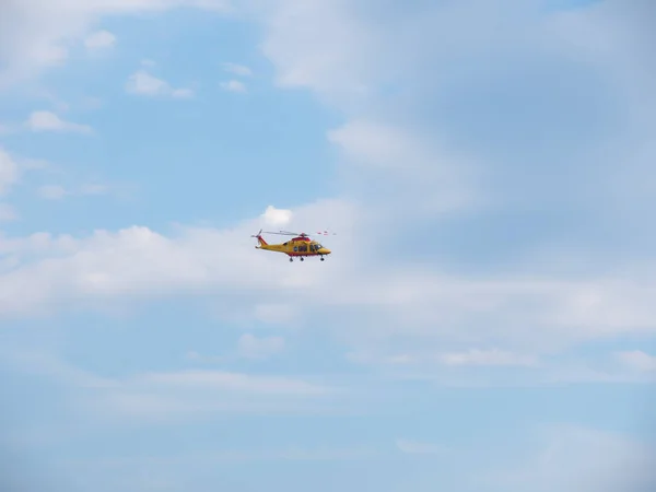 Rescue helicopter in the blue sky with clouds — Stock Photo, Image
