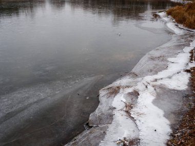Soğuk sonbahar sabahı, göldeki ilk buz.