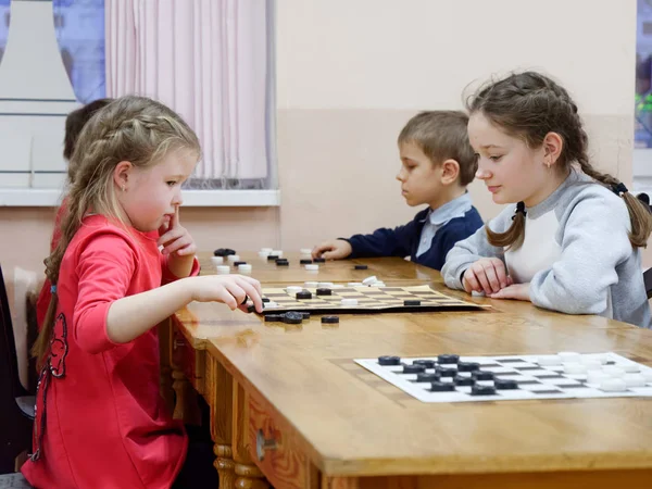 GOMEL, BELARUS - DECEMBER 29, 2019: Checkers chess competition among girls and boys. — 스톡 사진