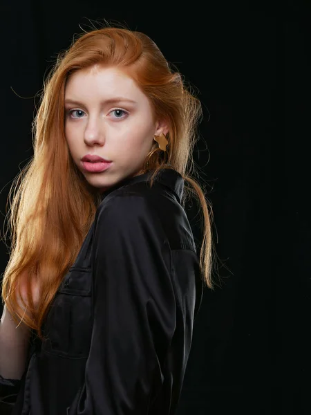 Young girl with long red hair on a black background — Stock Photo, Image