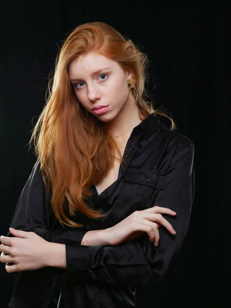 Young girl with long red hair on a black background — 스톡 사진