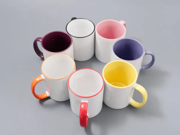 Colored cups for sublimation in composition on a gray background — 스톡 사진