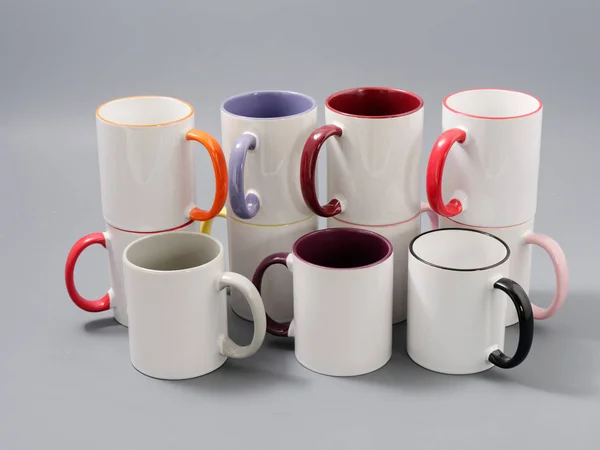 Colored cups for sublimation in composition on a gray background — Stock Photo, Image