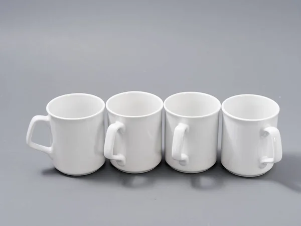 White cups for sublimation in composition on a gray background — 스톡 사진