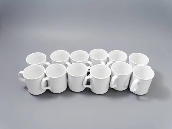 White cups for sublimation in composition on a gray background — 스톡 사진