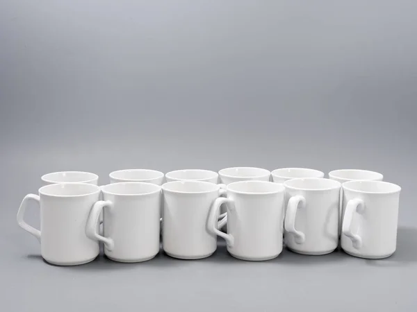 White cups for sublimation in composition on a gray background — 스톡 사진