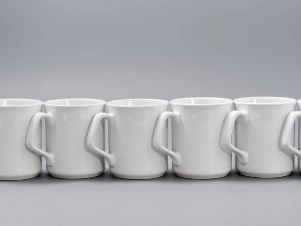 White cups for sublimation in composition on a gray background — Stock Photo, Image