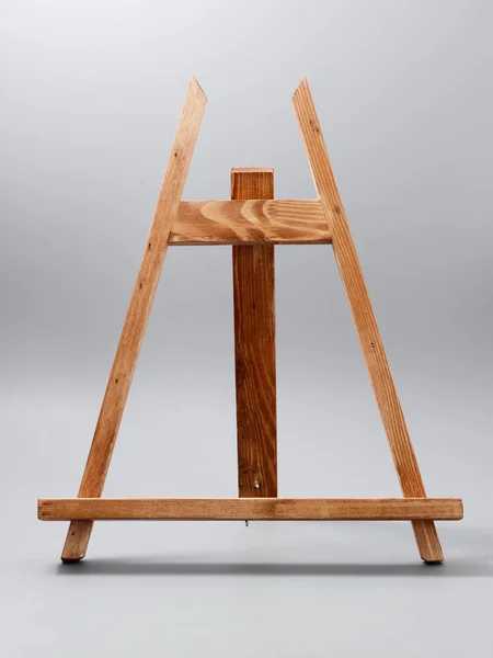 Easel made of wood table on a gray background — 스톡 사진