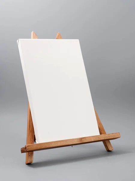 Easel made of wood table on a gray background — Stock Photo, Image