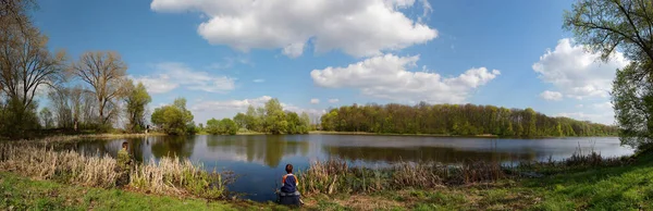 panorama of father and son fishing on a picturesque lake 2020