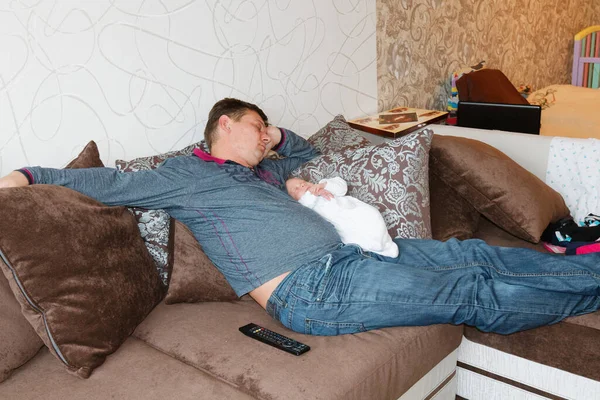 father and son baby sleep tired on sofa 2020