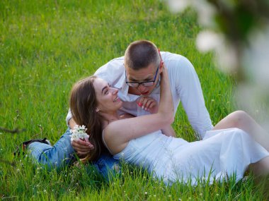 2020 bahçesindeki çiçek açan elma ağaçlarındaki genç adam ve kız.