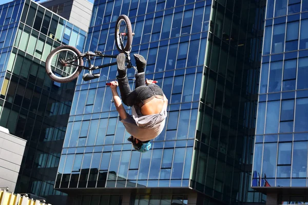 BMX sport jumping at a city background. Biking as extreme and fun sport.