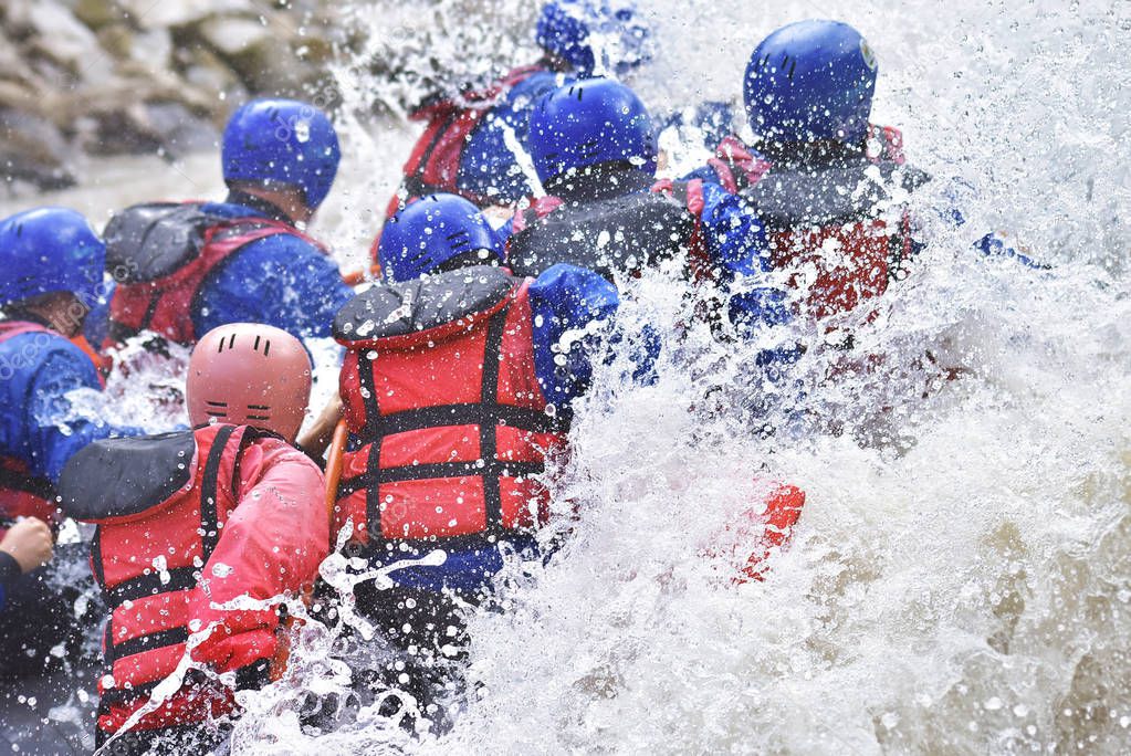 Rafting team splashing the waves, rafting extreme and fun sport