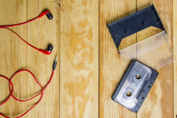 the cartridge for the tape recorder on a wooden table