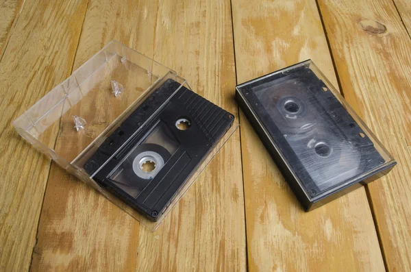 the cartridge for the tape recorder on a wooden table