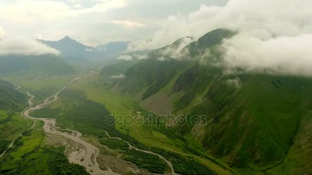 Mount Kazbek. View from above on a green mountain valley and mountain village — Stock Video