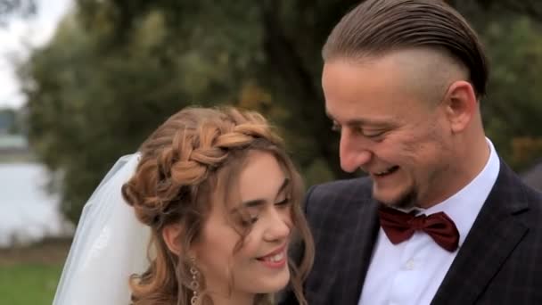 Portrait of newlywed couple in love in park — Stock Video