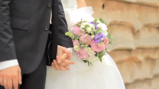 Bride takes the grooms hand. Wedding couple holding hands — Stock Video