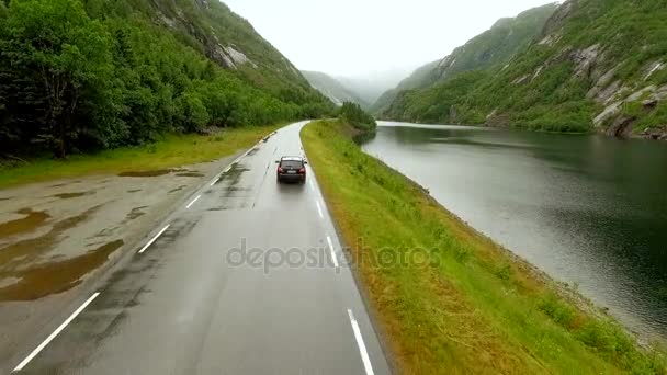 空撮。ノルウェーの美しい風景を背景に高速道路に沿って行く車. — ストック動画