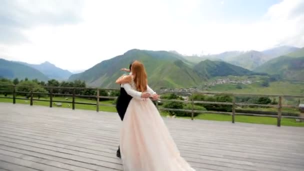 Groom Holding Bride Arms Circling Circle Wooden Terrace Hotel Mountains — Stock Video