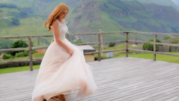 Tánc-hegységre a háttérben a gyönyörű vörös hajú menyasszony — Stock videók