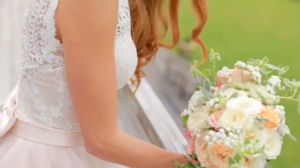 Gorgeous red-haired bride with a bouquet of flowers — Stock Video