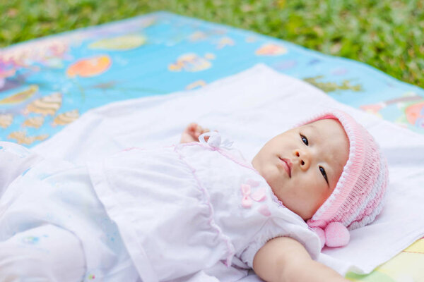 cute Asian baby lie on ground 