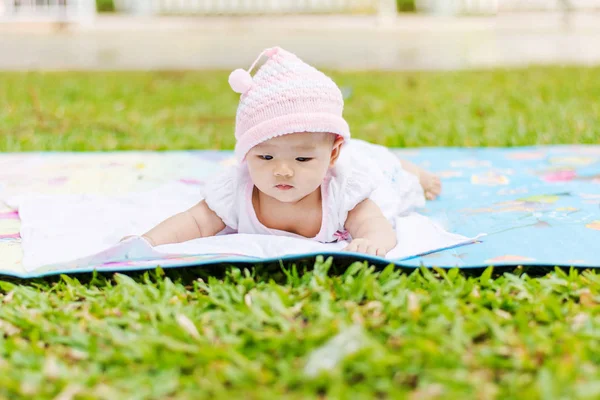 公園で地面に傾向があるアジアの赤ちゃんうそ — ストック写真