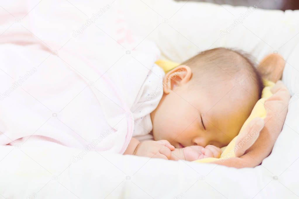 sweet baby sleeping  on bed at home 