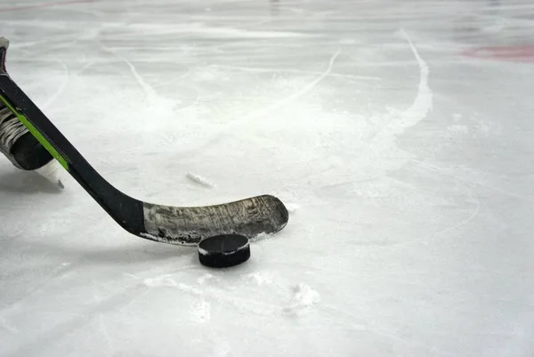 hockey stick with puck in the stadium